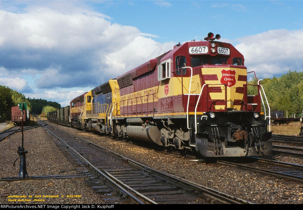 WC, Wisconsin Central SD45s 6607-5337-6541 leads a southbound ore train on the ex-Algoma Central at Hawk Junction, Ontario. September 23, 1995.